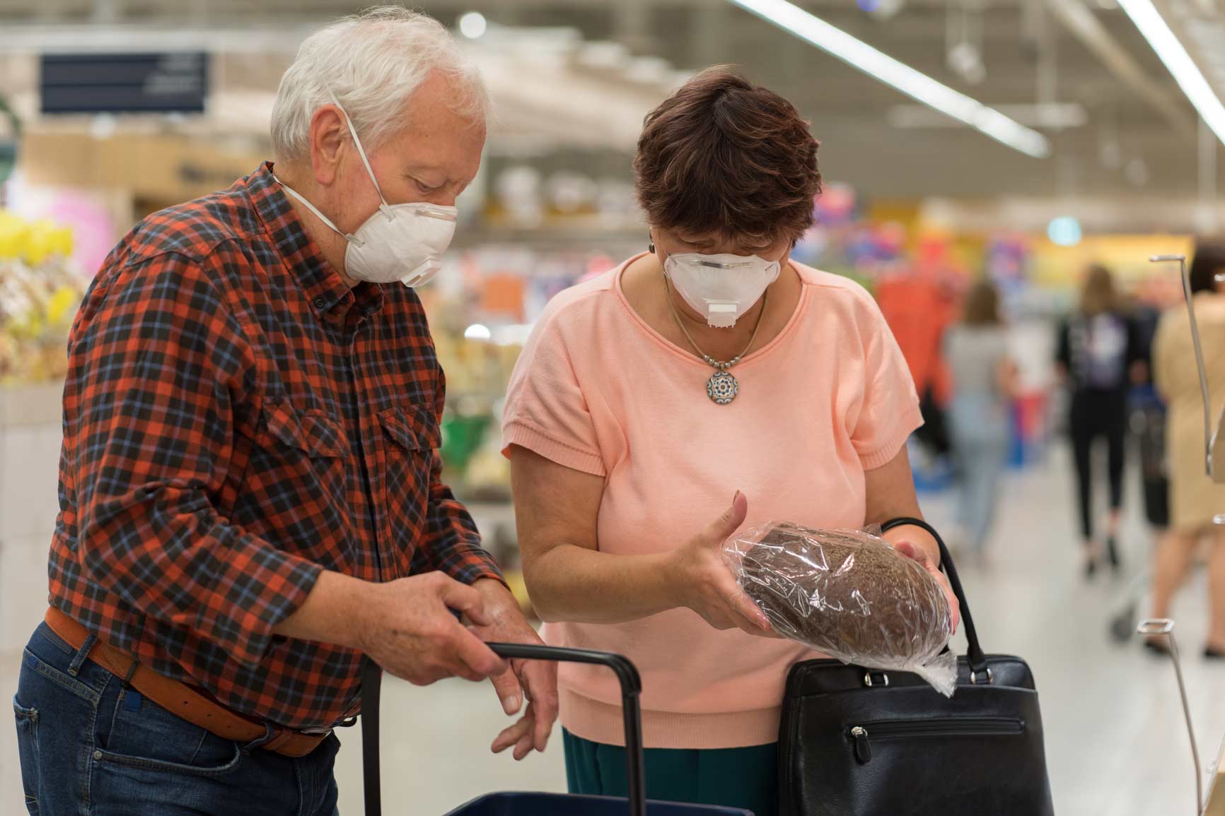 elderly couple shopping in face masks