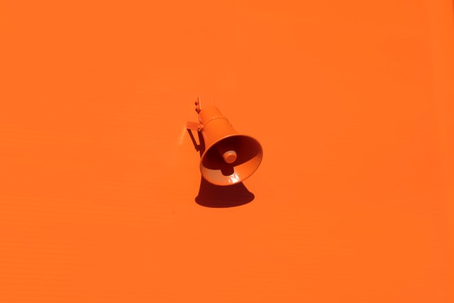 orange loudspeaker against orange background